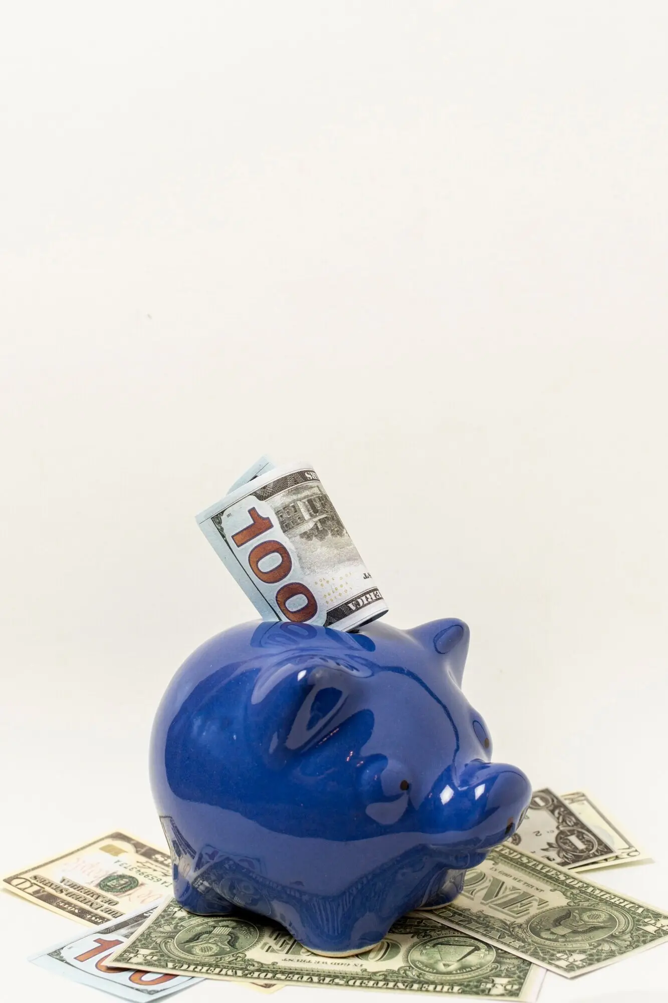 Blue piggy bank against a grey background with copy space.