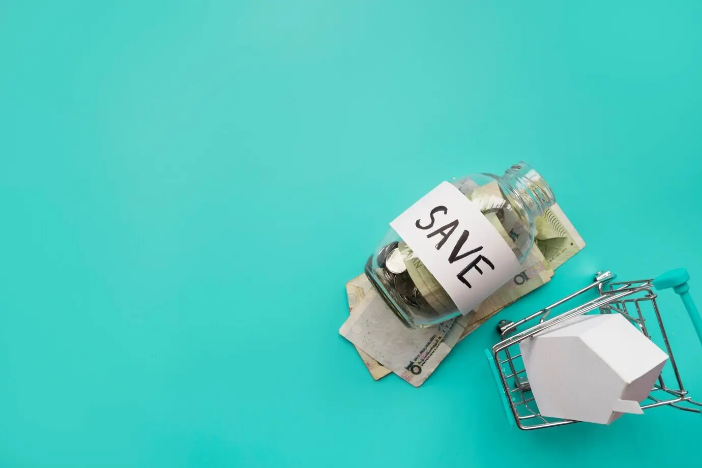 A savings jar with a miniature shopping cart.